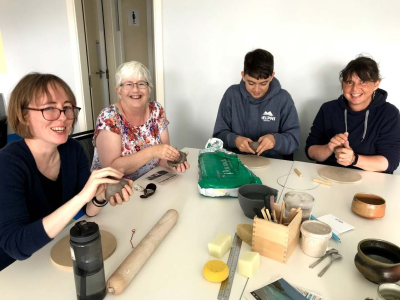 A group of people making clay fossils